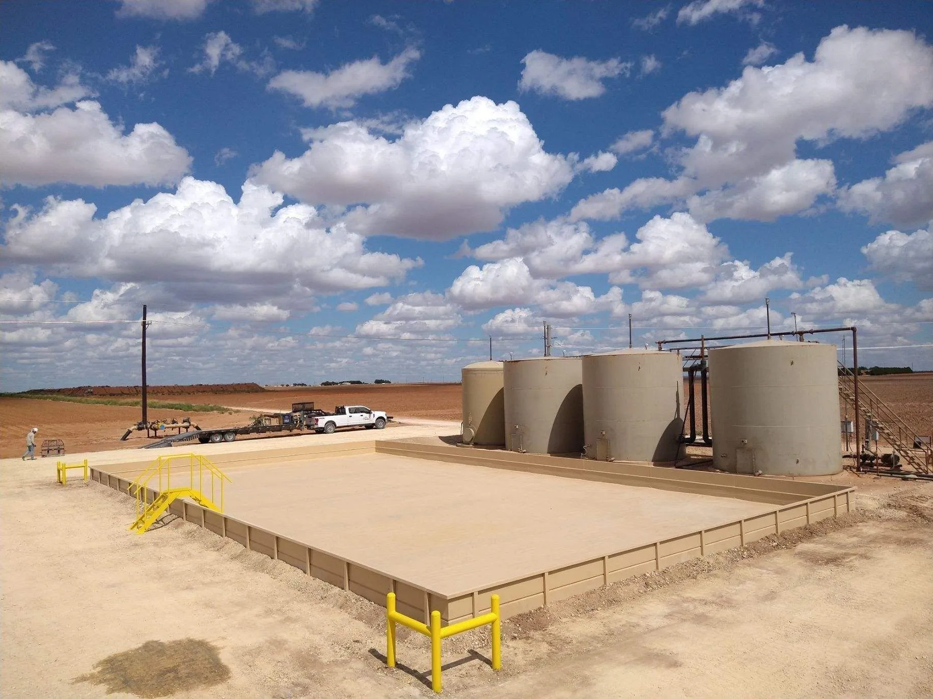 Tank Pads in Midland - TX under construction as equipment shapes and compacts a prepared industrial base