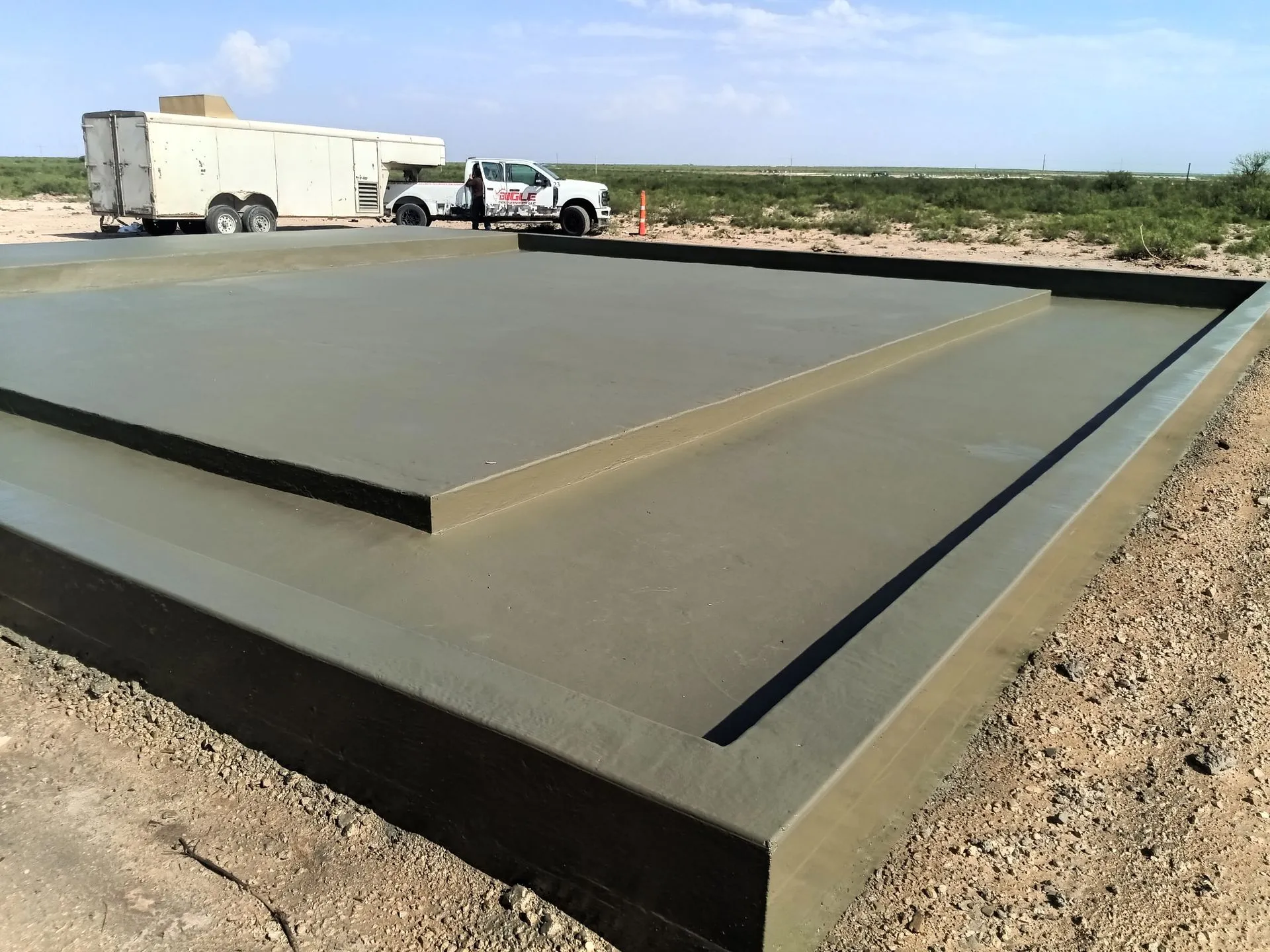 Concrete Coatings in Midland - TX being applied to a garage floor as installers spread protective material