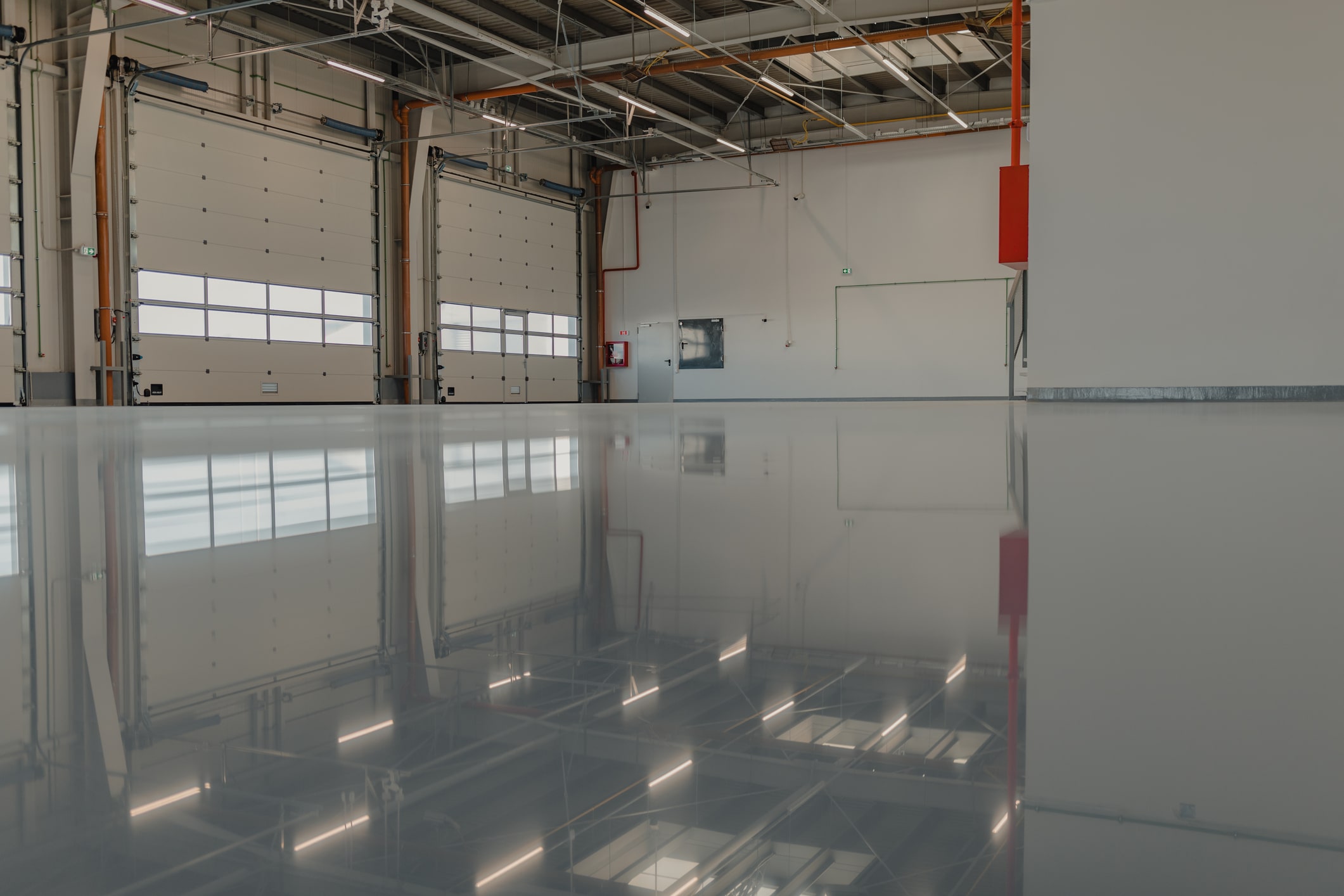 Crew restoring concrete coatings on a workshop floor in Midland - TX using surface preparation equipment