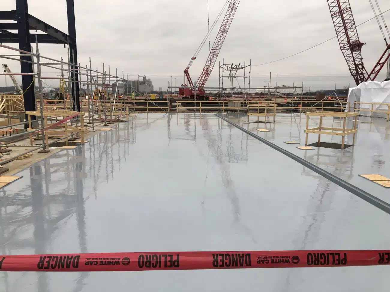 Crew inspecting Secondary Containment barriers around tanks at a Midland - TX industrial property