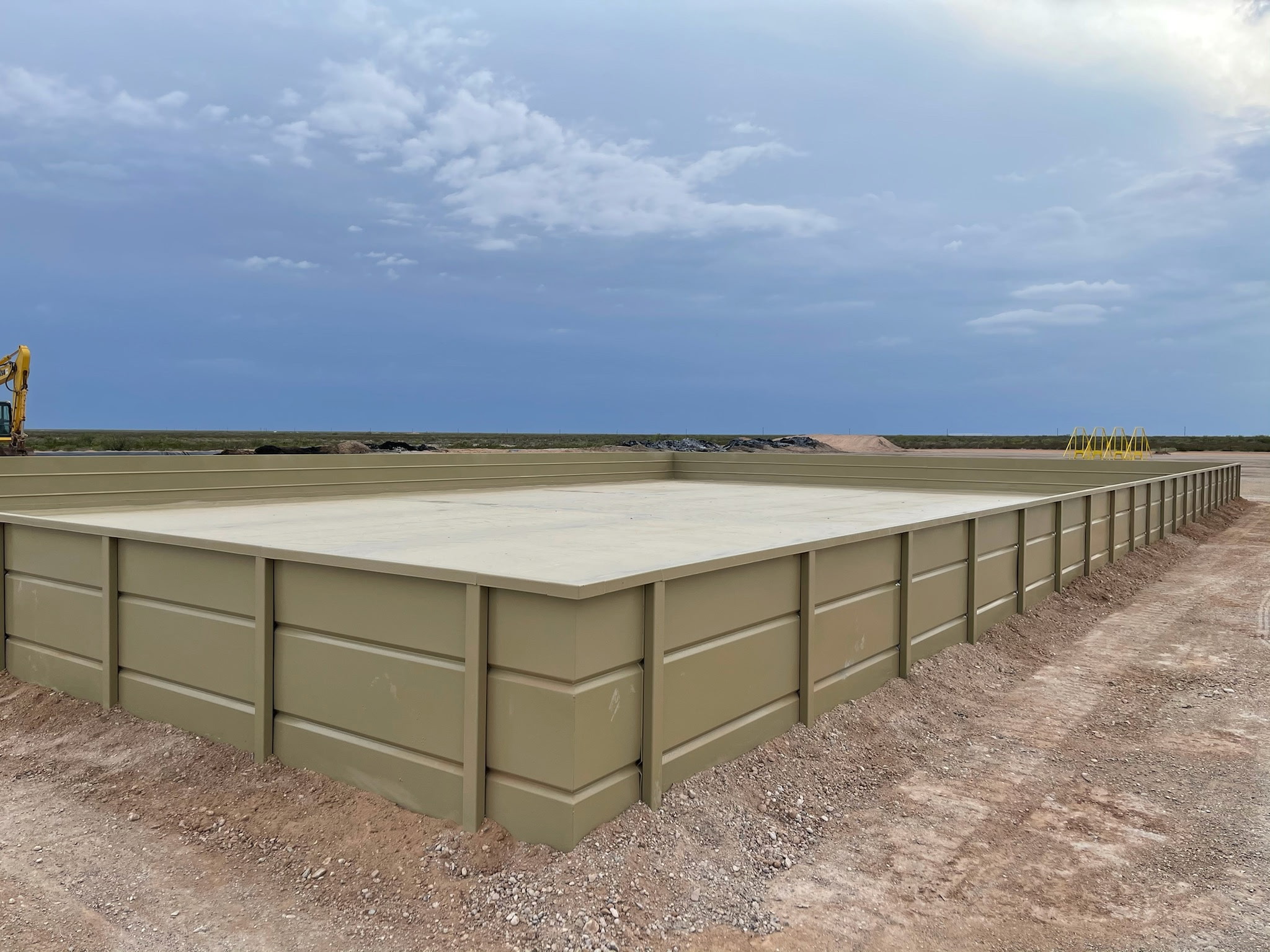 Crew inspecting Tank Pads on an active industrial site in Midland - TX before equipment placement