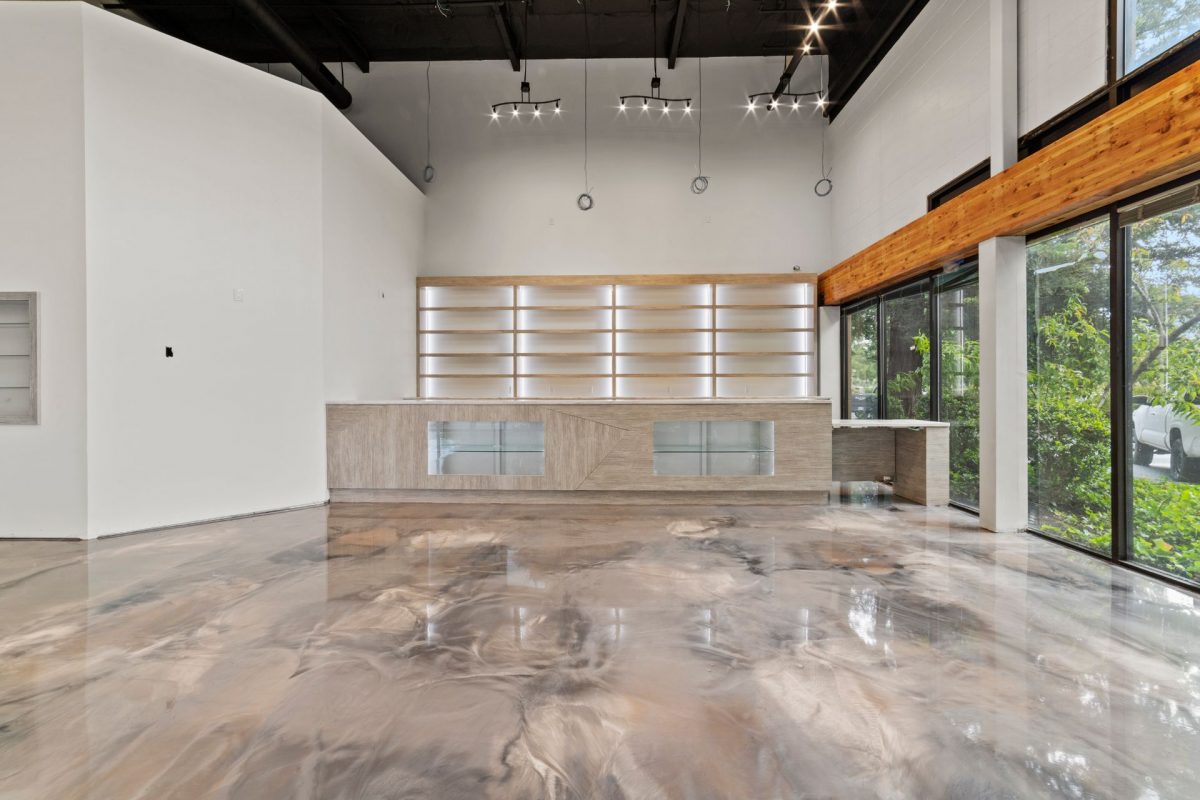 Crew restoring concrete coatings on a workshop floor in Midland - TX using surface preparation equipment