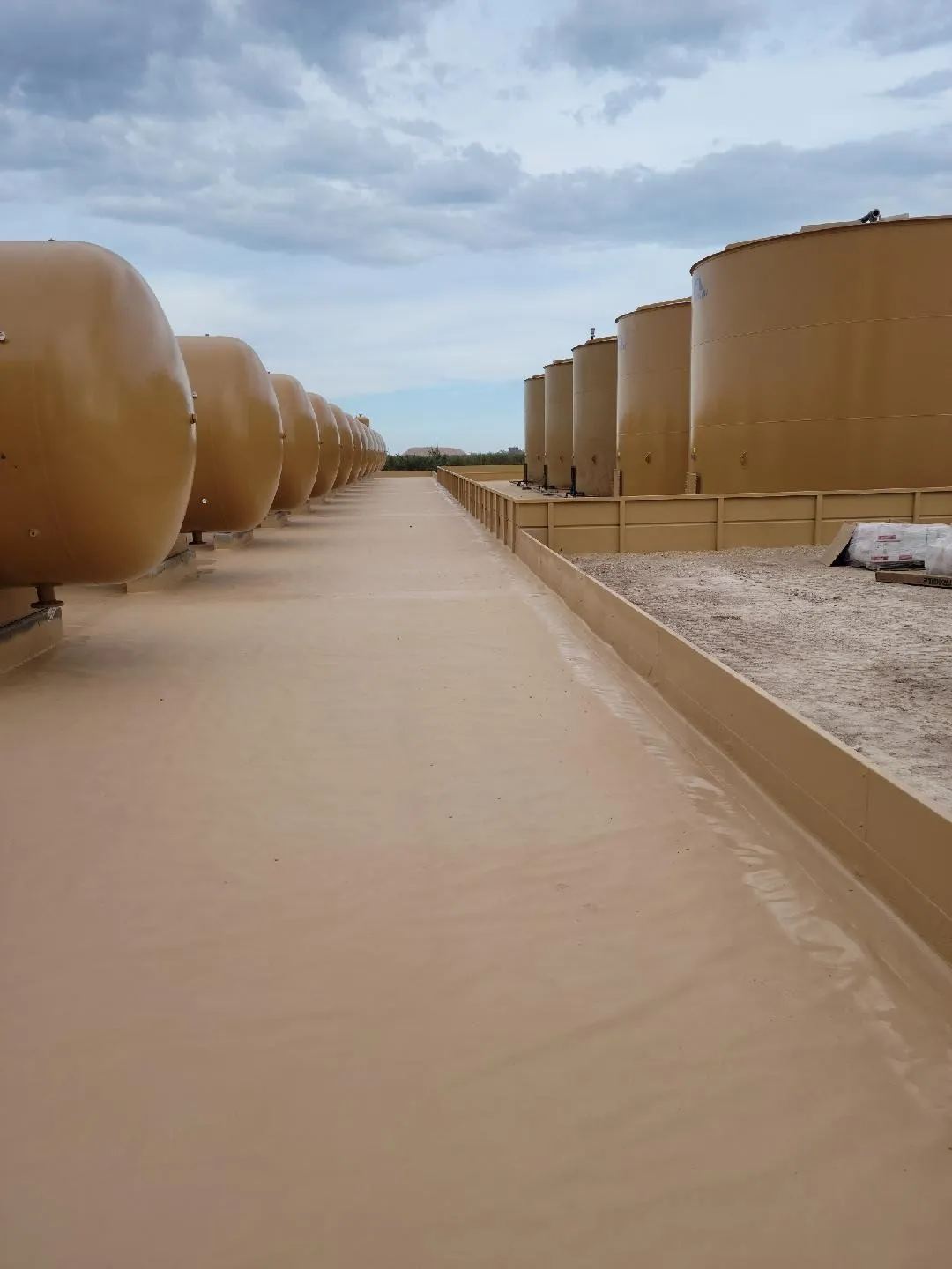 Crew inspecting Tank Pads on an active industrial site in Midland - TX before equipment placement